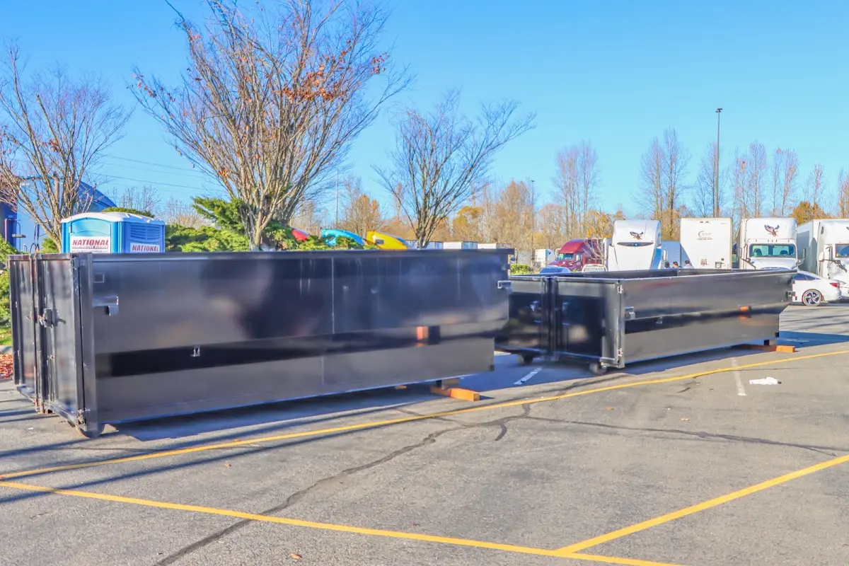 Professional dumpster rental service with roll-off container on residential driveway in Greenburgh